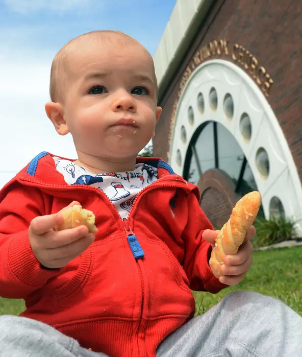 A young boy enjoying Koulourakia at the Holy Trinity Food Festival in Norwich, CT